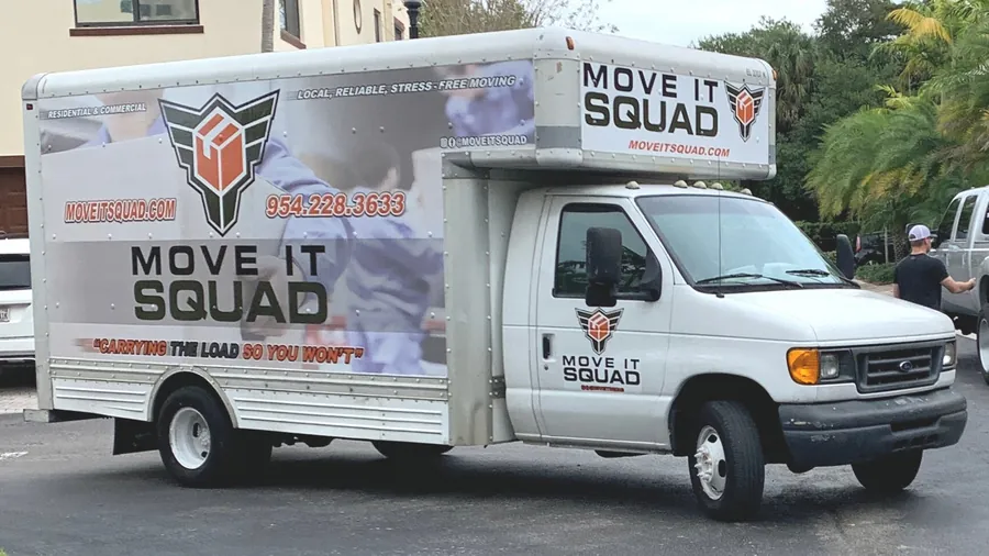 REAL photo of their own white Ford E-series box truck fully wrapped: 'MOVE IT SQUAD', winged box logo, 954.228.3633, MOVEITSQUAD.COM, 'Local