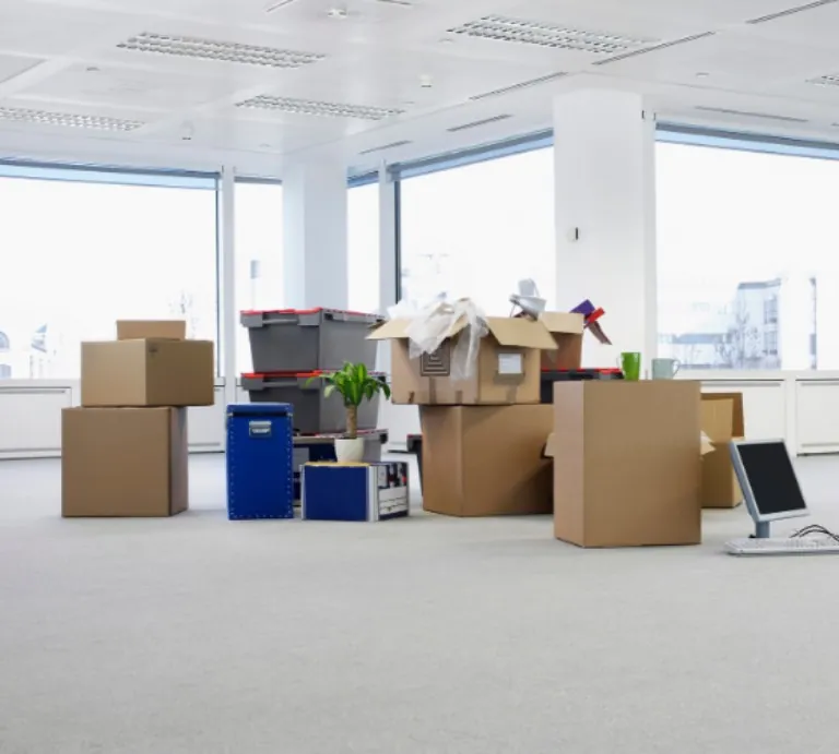 Office floor with moving boxes and equipment ready to go